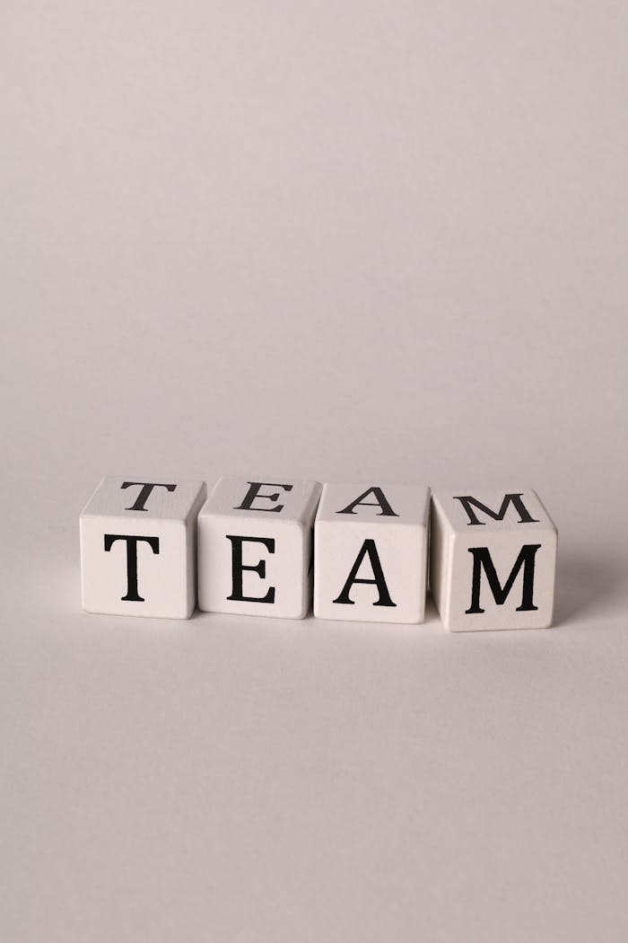 White blocks spelling 'TEAM' on a plain background, symbolizing collaboration.